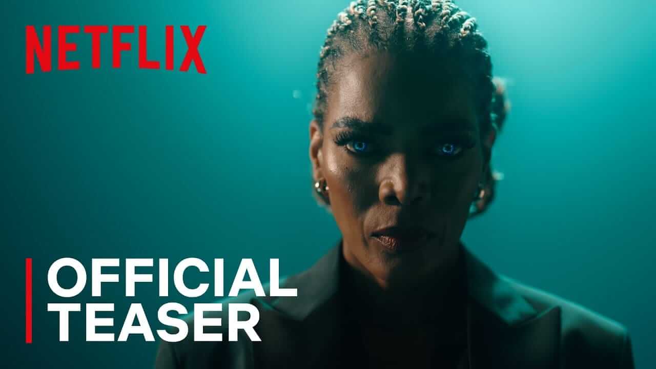 News 121 A person with braided hair, glowing blue eyes, and serious expression stands against a teal background. They wear a dark blazer and hoop earrings. The image features the red Netflix logo and white text reading “OFFICIAL TEASER” in the lower left corner.